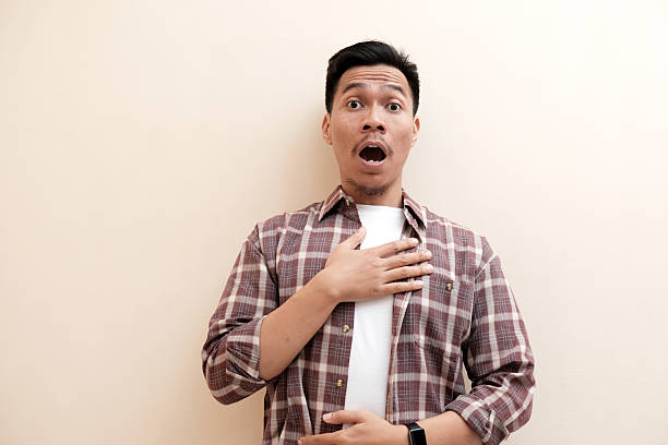 istock Southeast Asian man wearing flannel shirt showing shocked face expression 2250267839