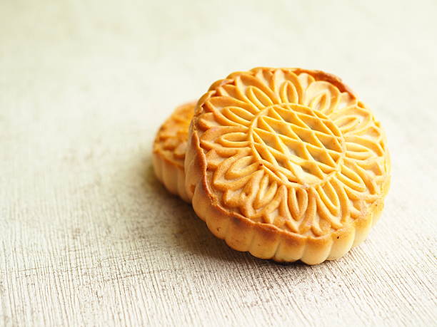 istock Two golden brown cakes with intricate floral design on a textured surface, close-up composition. 2250275434