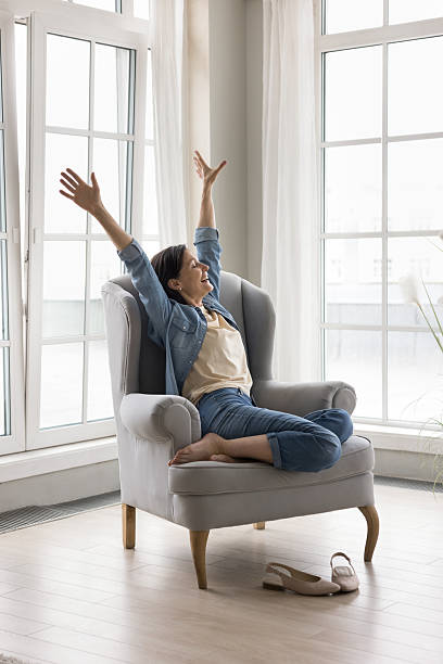 istock Happy woman raised her arms do stretching exercises feel rested 2250278894