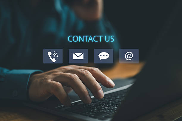 istock Contact us or Customer support hotline people connect. Businessman using a laptop and touching on virtual screen contact icons ( email, address, live chat, phone ). customer service. 2250281591