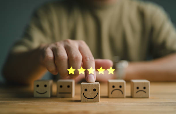 istock customer services best excellent business rating experience. Satisfaction survey concept. Hand of a businessman chooses a smile face on wood block circle. 5 Star Satisfaction. 2250281686