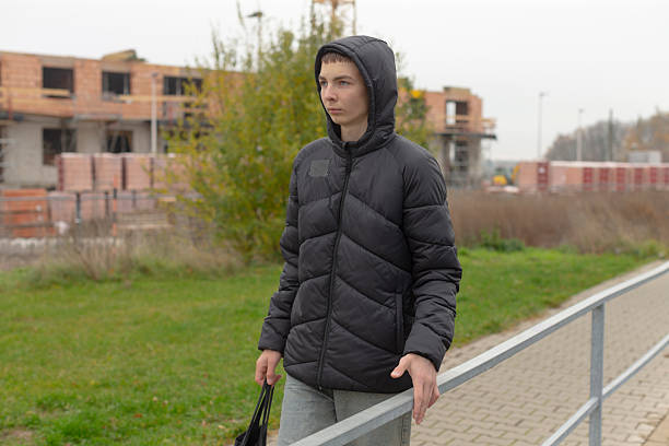 istock Youth contemplating environment, Young male observes construction scene 2250281901