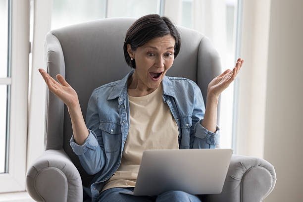 istock Happy woman looking at laptop screen screaming with joy 2250284000