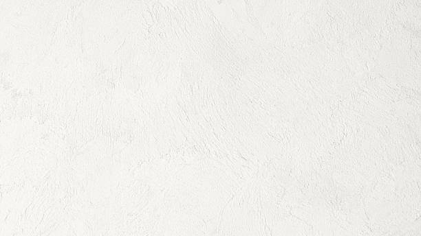 istock White textured concrete wall in Cloud Dancer color background 2250287109