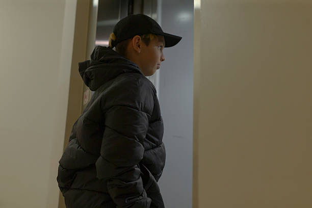 istock Adolescent focused on entrance with serious expression in hallway 2250288928