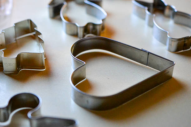 Traditional Finnish gingerbread cookie cutters in classic Christmas shapes on a light surface, symbolizing homemade Christmas baking and winter traditions in Finland.finnish christmas | finland | gingerbread cookie cutters | christmas baking | cookie shapes | holiday tradition | nordic winter | piparkakut