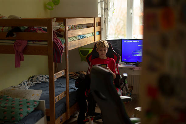 istock Young person enjoying leisure time with glowing screen in room 2250290509