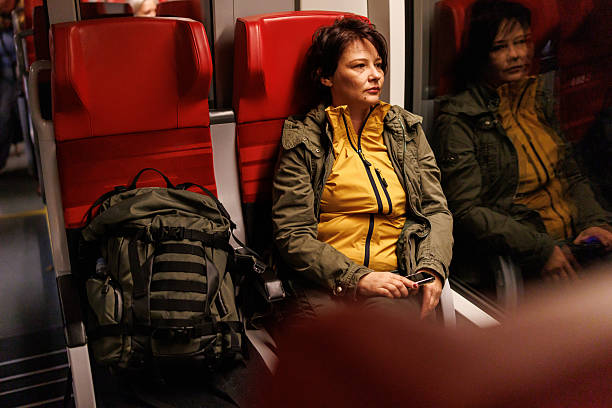 istock Woman sitting next to the train window with her reflection visible 2250291264