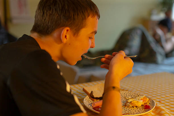 istock Youth dining alone, Young person having quiet meal in warm environment 2250293615