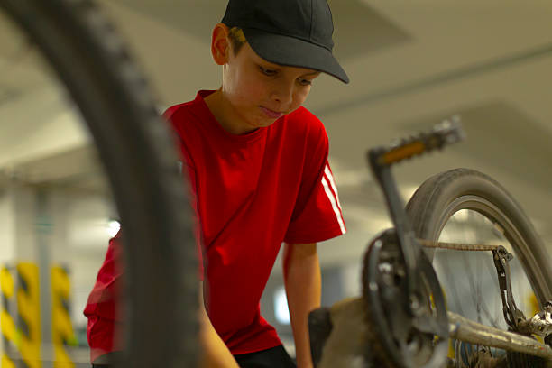 istock Youthful individual scrutinizing bicycle components in dim conditions 2250293777