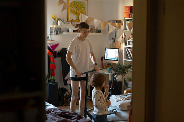 Youthful gaming scene, Sibling guides younger through gaming activities