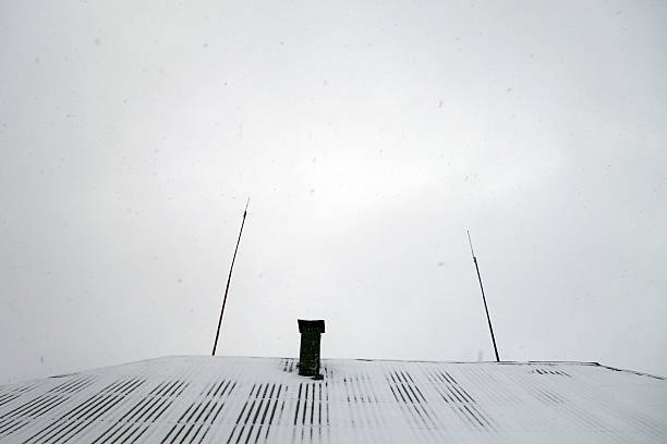 House roof with chimney covered with snow. Architectural background