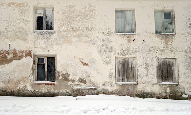 Abandoned ancient house in winter. Seasonal scene.