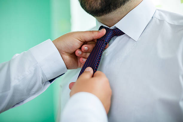 istock man puts on a suit on the wedding day 2250298474