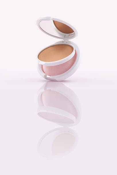 istock Opened compact powder included mirror and makeup puff on glossy surface 2250299436
