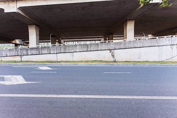 istock Concrete structure and asphalt road space under the overpass in the city 2250300958