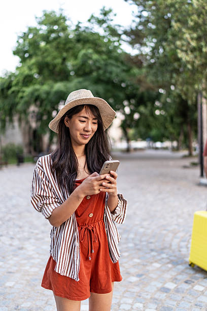 istock Woman traveling on vacation using smartphone for navigation 2250301179