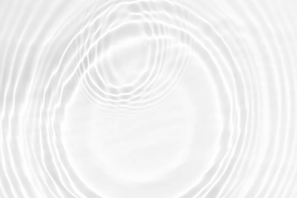 istock White water with ripples on the surface. Defocus blurred transparent white colored clear calm water surface texture with splashes and bubbles. Water waves with shining pattern texture background. 2250301404