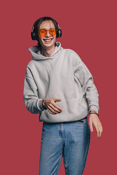 istock Young individual with headphones expressing lively dance gestures 2250304661