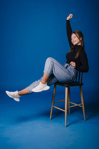 istock young woman freelancer stretching on stool during break 2250306561