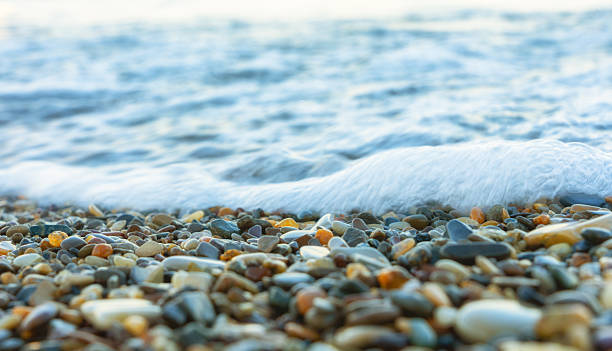 istock Sea wave rolling over colorful pebbles on the shore 2250309526