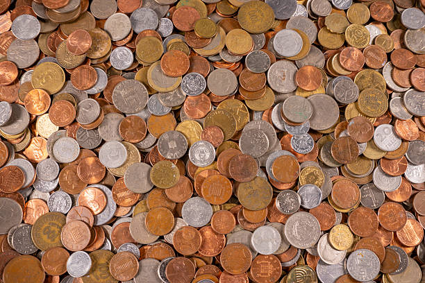 istock Variety of coins scattered on a flat surface in a collection display 2250310169