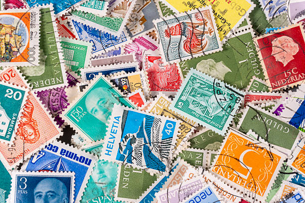 istock Collection of colorful stamps from various countries on a flat surface 2250314207