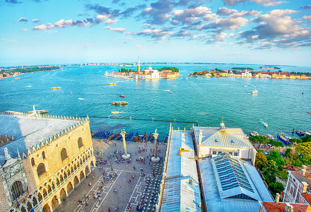 View of the Piazzetta San Marco, the smaller extension of St Mark’s Square, with the bright turquoise lagoon beside the ornate façade of the Doge’s Palace and the two iconic columns