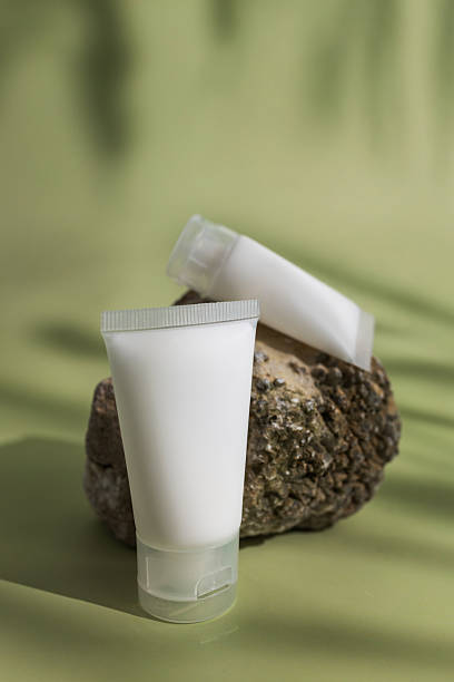 istock Cosmetic cream tubes on natural stone with soft 2250318296