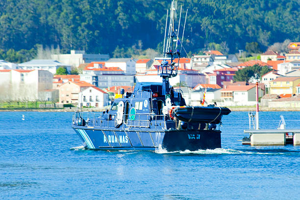 Customs ship sailing out of Muros harbor. A Coruña province, Galicia, Spain.