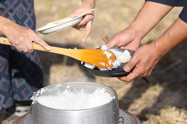 istock A woman serving freshly cooked rice 2250320145