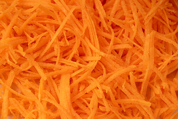 istock Fresh Finely Grated Carrots Textured Background, Raw Carrot Pieces Closeup Pattern 2250321475
