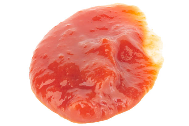 Close up image of french fries dipped in tomato sauce.