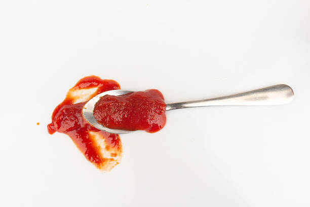 istock tomato ketchup isolated on white background spoon 2250321514