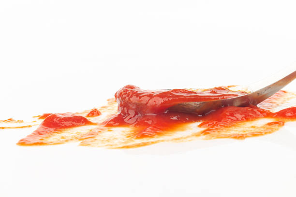 istock tomato ketchup isolated on white background spoon 2250321554