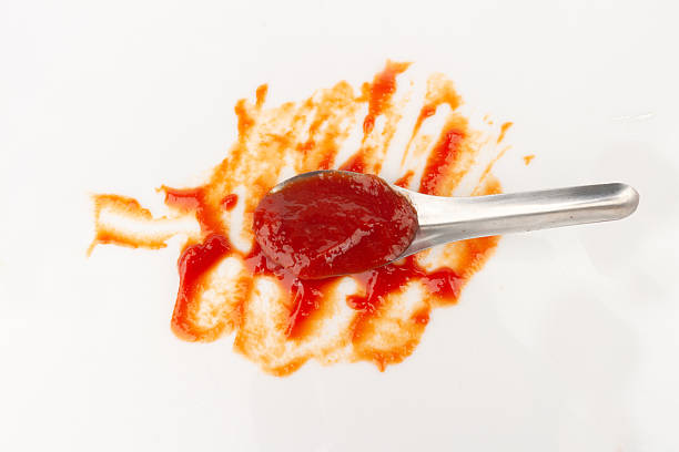 istock tomato ketchup isolated on white background spoon 2250321557