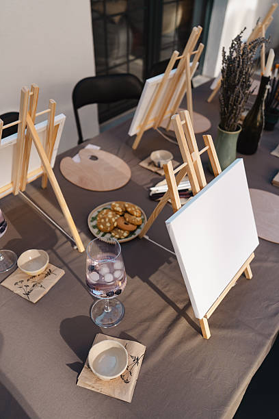 istock Art class setup with easels, canvases, drinks, and snacks 2250321560
