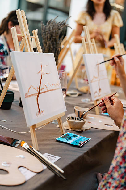 istock Art class with easels, paintbrushes, and paintings in progress 2250321655