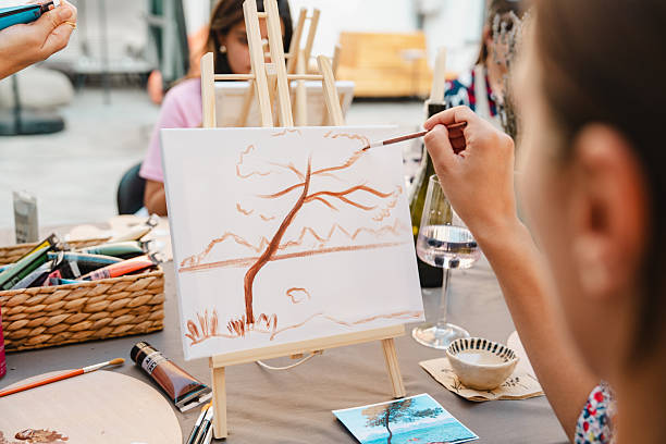 istock Art class, painting a tree on canvas with friends and wine 2250321683