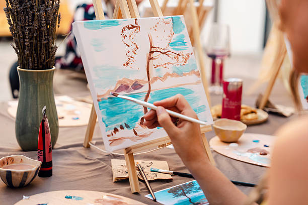 istock Art class with students painting landscapes on canvas 2250321800