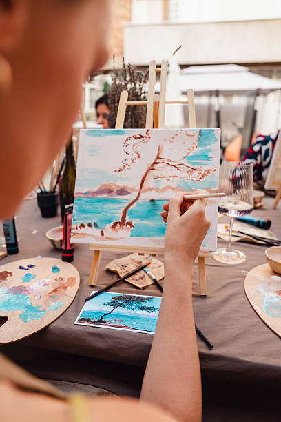 istock Outdoor art class with students painting a landscape on canvas 2250321850