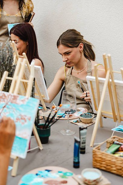 istock Art class outdoors with friends painting on canvas with brushes and paint 2250321974