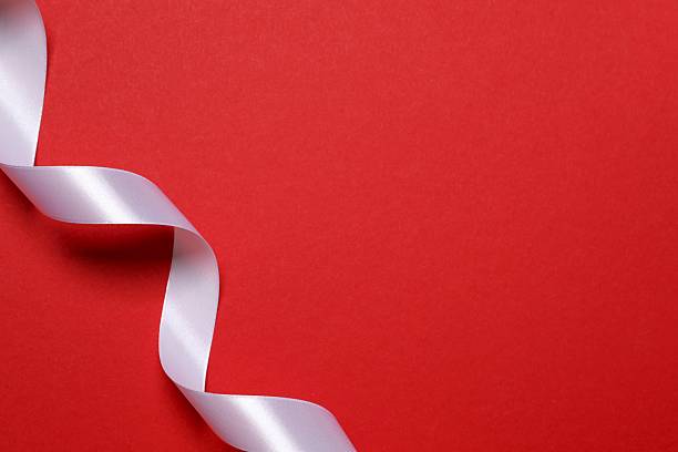 istock Beautiful white silk ribbon on red background, space for text 2250327851