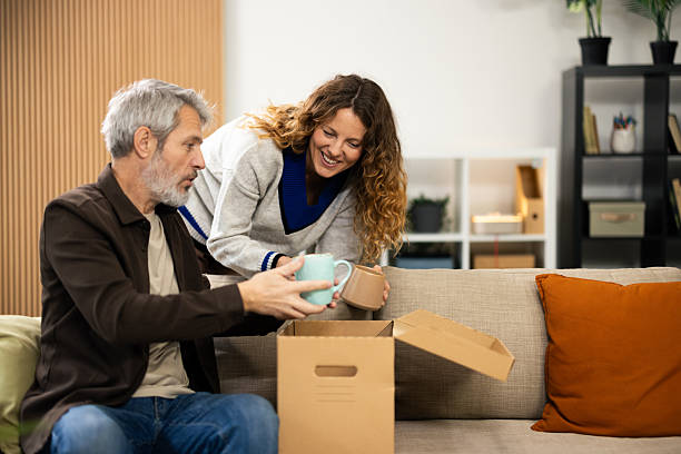 istock Happy couple unpacking boxes moving into new home 2250328636