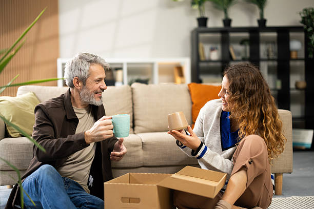 istock Happy couple unpacking boxes in new apartment relaxing 2250328652