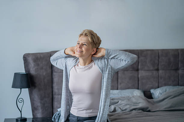 istock Woman stretching in bed after waking up 2250328891