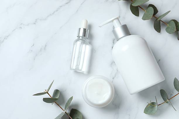istock Natural cosmetic products with eucalyptus leaves on marble background, top view 2250329242