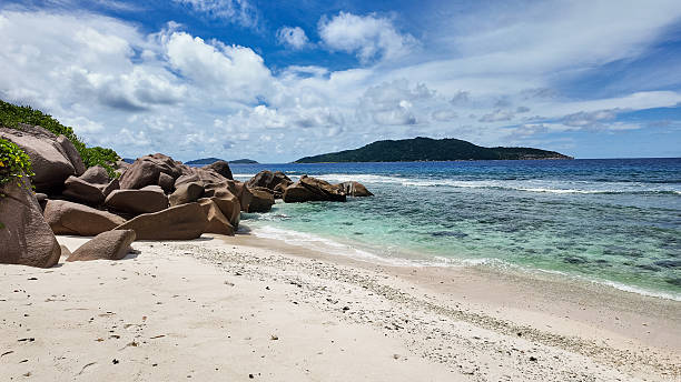 istock Scenic tropical beach with turquoise waters and granite rocks. 2250332273
