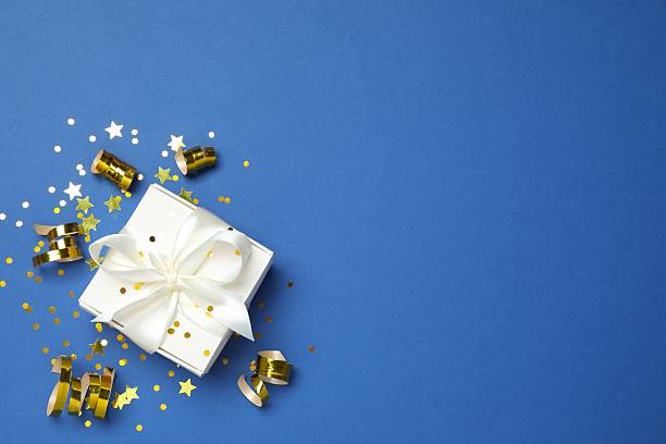 istock Creative gift box with confetti on color background, top view 2250336526