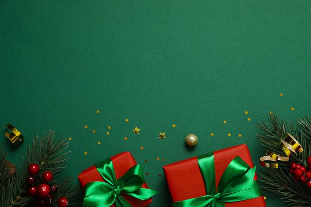 istock Festive gift boxes tied with bows, Christmas decorations, confetti on color background 2250336646